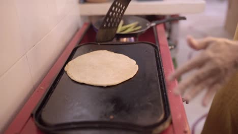 woman preparing pancakes on pan