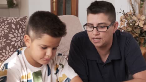 mother helping her children do crafts at home