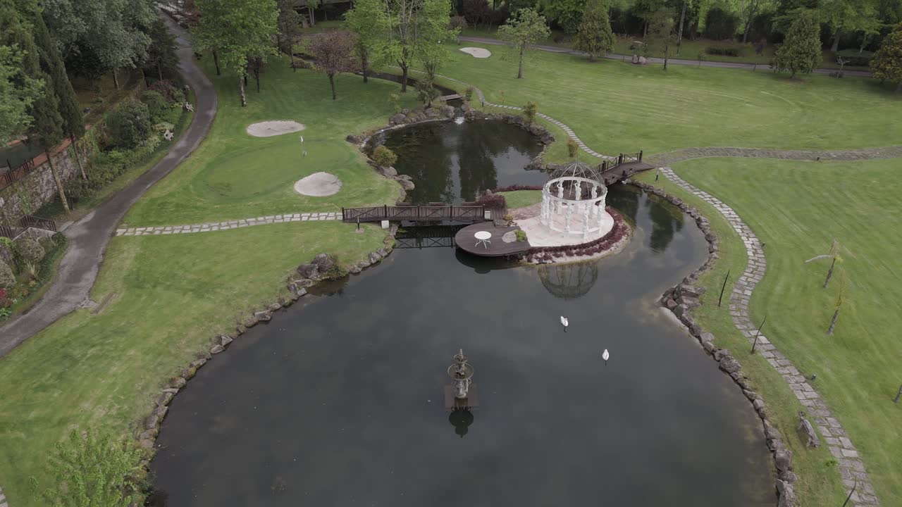 lush green park with pond stone paths and elegant central gazebo