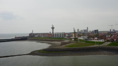 Aerial-orbit-panorama-of-Vlissingen-with-waterfront-towers-and-fortified-piers
