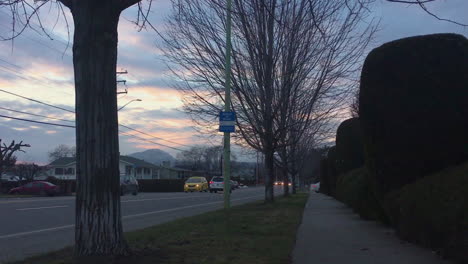 Sunset-over-neighborhood-sidewalk-and-calm-traffic