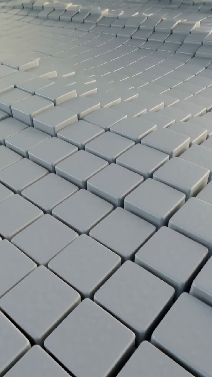 Vertical video: Gray tiles rippling from lowerleft pulse camera tilting up showing lifts for design