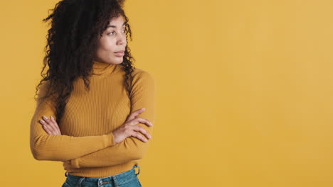 african american confident woman over orange background.