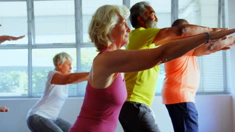 Side-view-of-active-mixed-race-senior-people-exercising-in-the-fitness-studio-4k