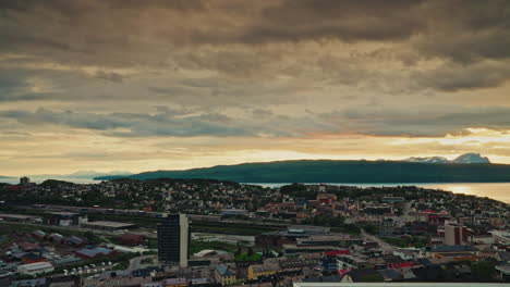 midnight sunset over the nordic city of narvik in norway. view of the majestic fjords, the norwegian sea and the cloudy, golden sky.
picturesque arctic landscape.