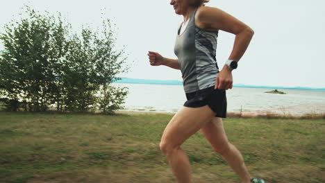 woman jogging along lakeside