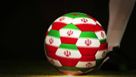 football player kicking iran flag ball