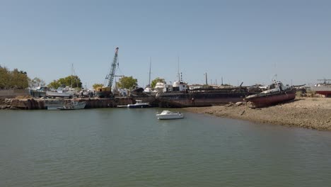 drone approaching shipyard on the banks of gilao river in santa maria, portugal