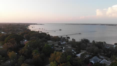 Aerial-Shot-of-South-Florida-Neighborhood-With-Docks-Leading-Out-into-River-During-Sunset