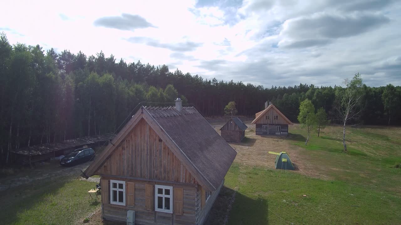 imágenes aéreas desde la casa con techo de paja hasta el bosque sin fin
