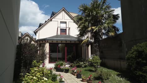 house with a garden and palm tree