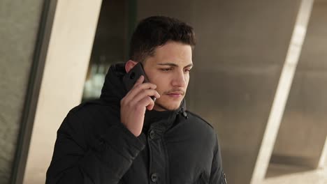 upset young man talking on phone outdoor