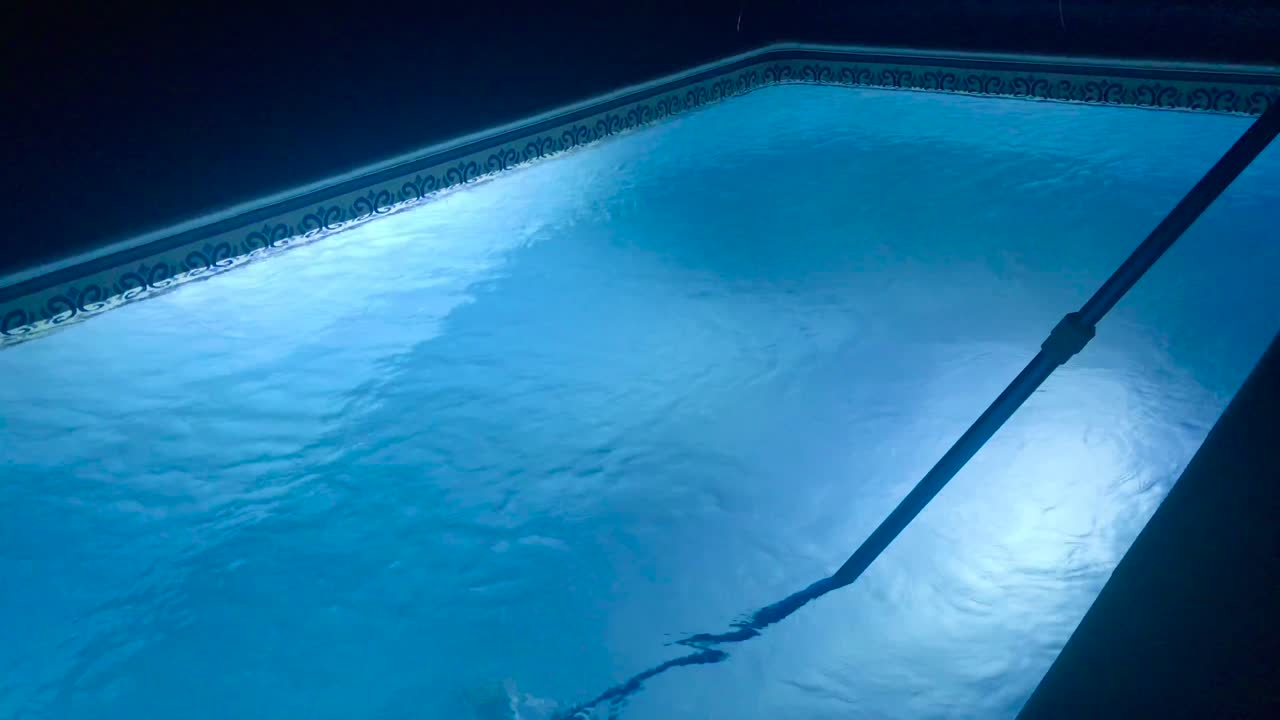 Night shift maintenance of private open-air swimming pool with LED lights in 4k