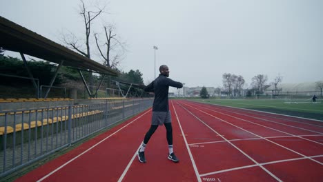 man stretching on a track