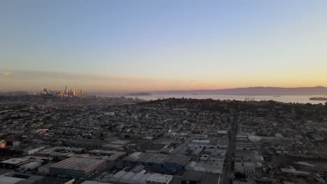 A peaceful drone flight pans over a San Francisco neighborhood, offering a tranquil view of the city&#039;s downtown buildings bathed in the gentle morning glow
