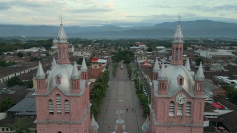 aerial view of a town with prominent twin church towers and a central plaza