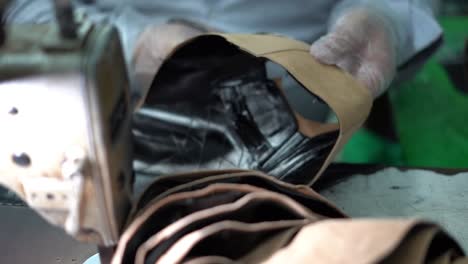 a craftsman handmade a bag by scissor, close up shot, insert shot
