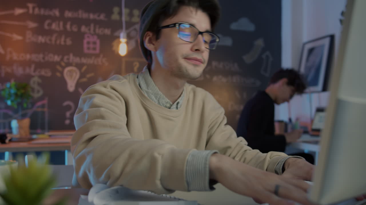 Young Person Working on a Laptop in a Modern Office