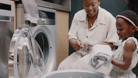 mom, child smile and teaching laundry together