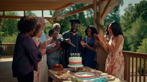 graduation celebration with family and friends cutting the cake