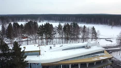 aerial view of a modern building in a snowy forest