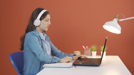 young woman closing laptop with angry expression.