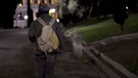 homeless stand up and  walking in the city park at night