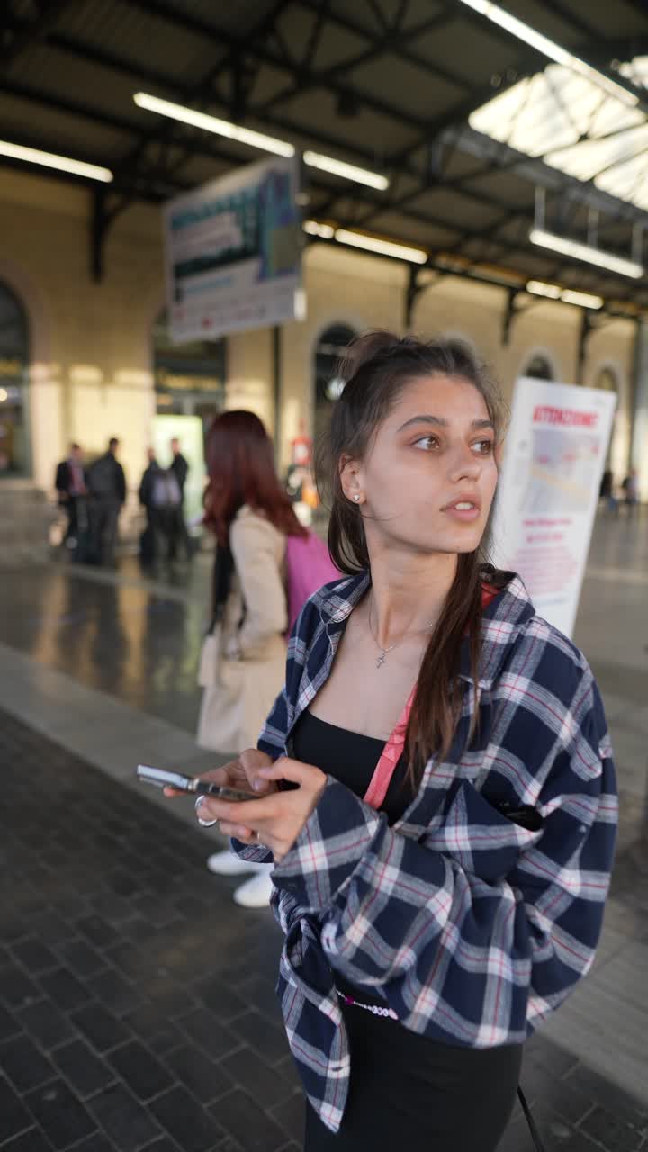 Teenage Girl at Train Station Using Phone