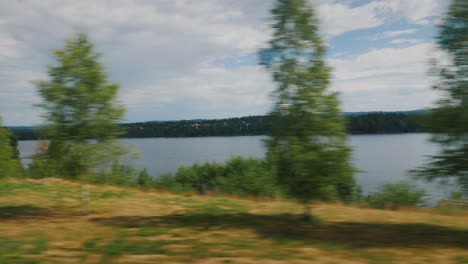 travel along a scenic road along a lake in sweden 4k video