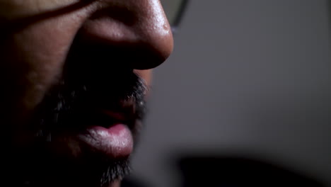 close-up of a man engaged in conversation, highlighting the portrayal of facial expressions, gestures, and communication