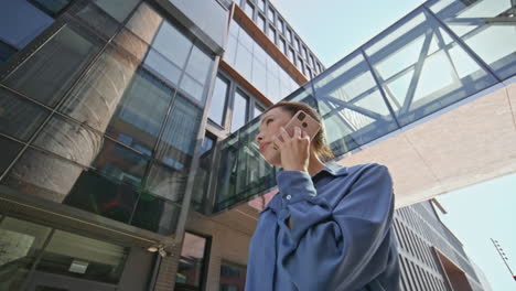 manager discussing work smartphone standing at modern office building close up.