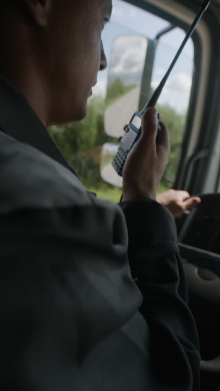Man driving a truck using a radio