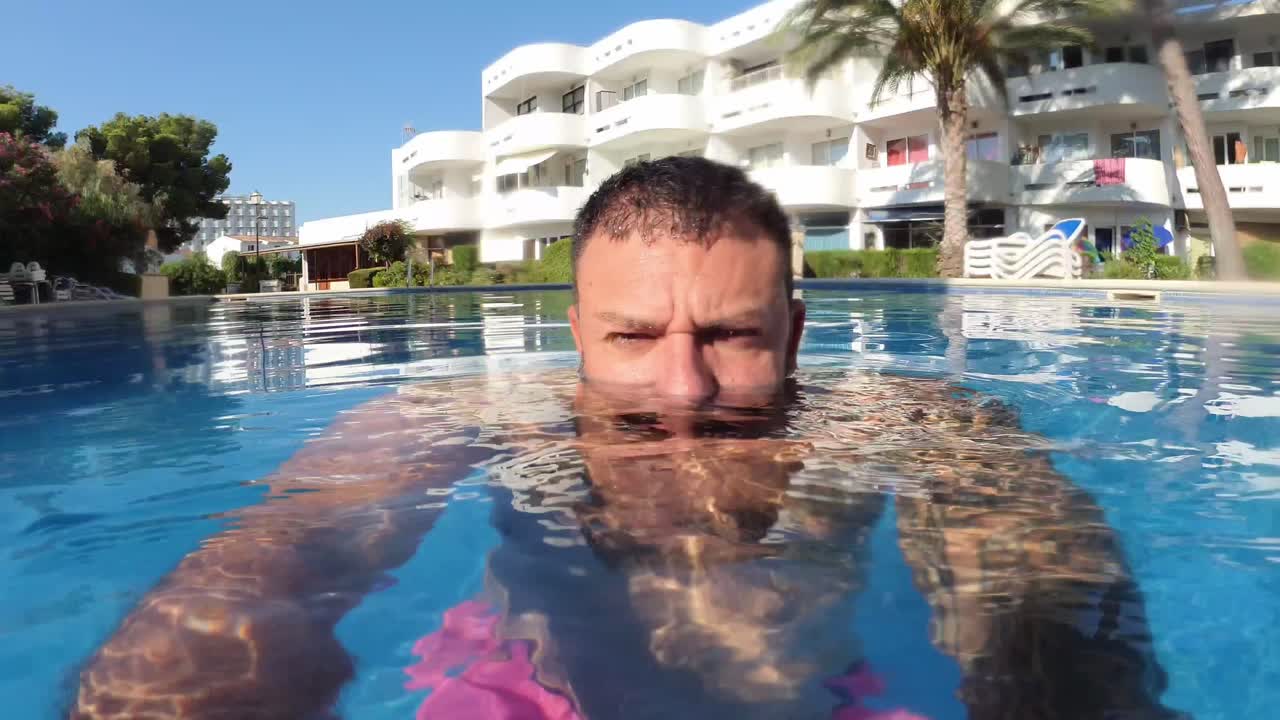 man on vacation in the pool
