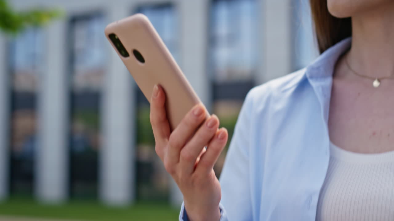 Businesswoman browsing cellphone go hurrying on work closeup. Lady reading