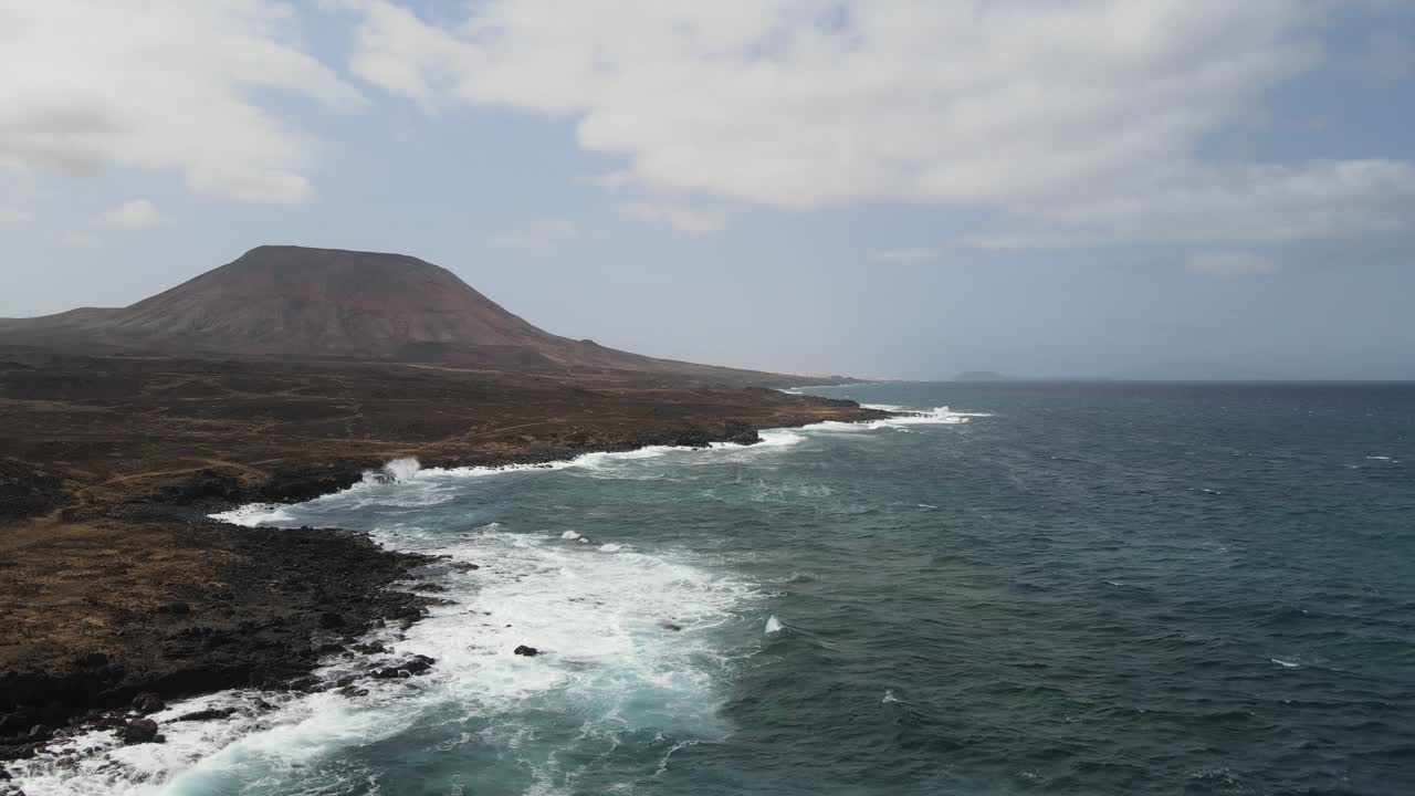 aerial drone shot of a massive volcano in a unreal volcanic landscape in Fuerteventura in the Canary Islands