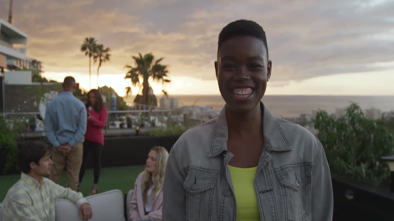 Young African American woman smiling at camera on a rooftop