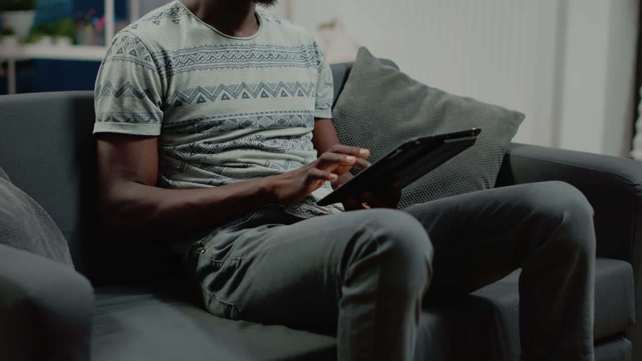 Close up of adult looking at digital tablet after remote work