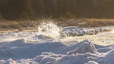 aggressive and strong ocean waves hitting icy coastline, slow motion