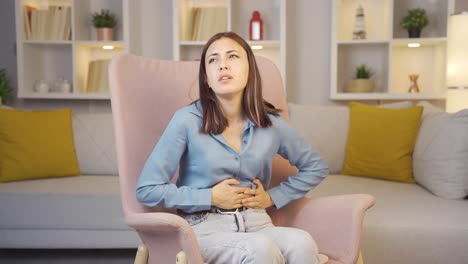 young woman experiencing stomachache.