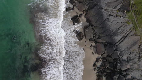 waves crushing in on a secluded beach shore