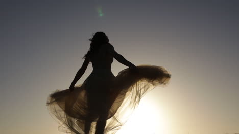 silhouette of girl dancing in sunset