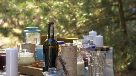 table setting of a traditional meal with candle and bottle of wine on nature landscape in arendel, zagorow poland