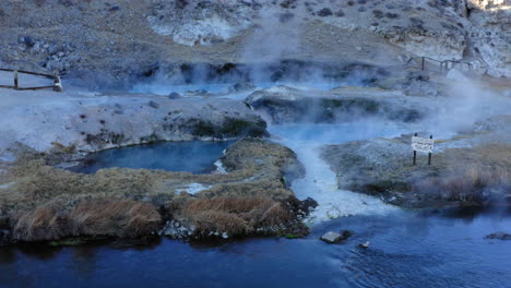 Flyover-Steaming-Hot-Spring,-Hot-Creek-Geological-Site,-Travel-Destination,-Aerial