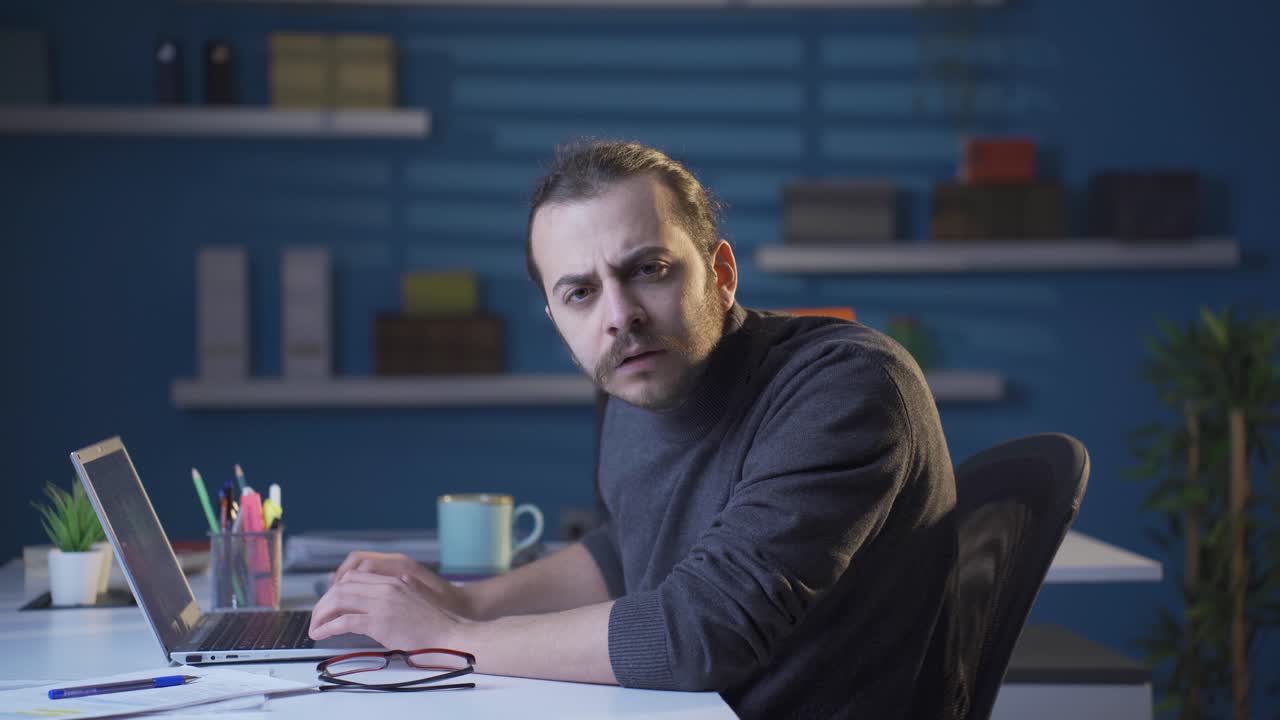 Businessman looking at camera with curiosity and focus. Listening to news and announcements.