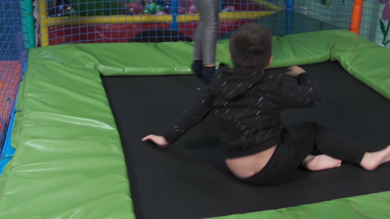 Children jump on trampolines in the children's entertainment center. Children have fun in the playground