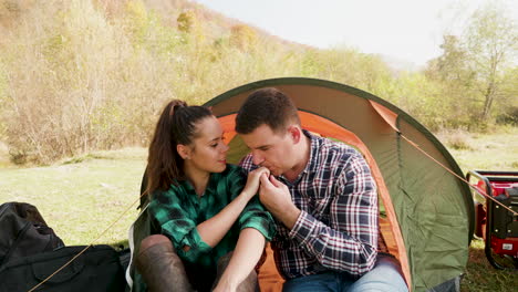 caucasian young couple camping near the mountains