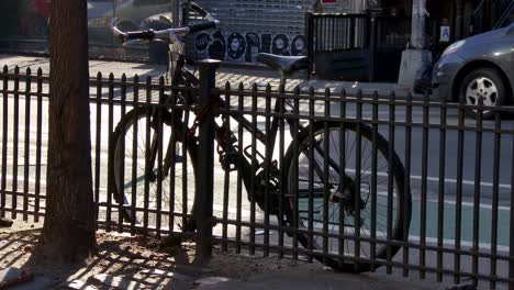 bicycle parked next to fence  on the street