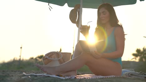 Beautiful-woman-relaxes-on-the-beach-under-an