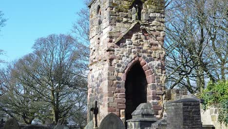 Historic-Windleshaw-Chantry-stonework-tower-exterior-slow-motion-around-graveyard-remains-and-blue-sky