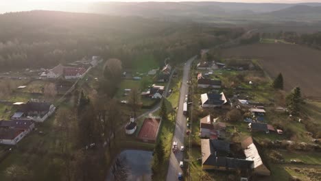firefighters drive through a village on a sunny winter day. aerial view from a drone. heavy equipment exit. czech republic, europe